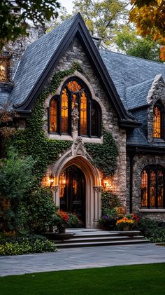 a house with ivy growing all over it's walls and windows on the front