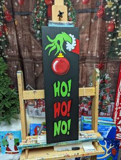 an easel with a sign on it that says ho hoo no in front of a christmas tree