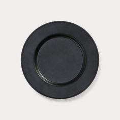 an empty black plate on a white background