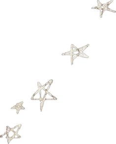 five silver stars are flying in the air together, with one star falling off it's side