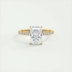 an engagement ring with a princess cut diamond in the center and pave set shoulders