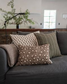 a couch with several pillows on top of it