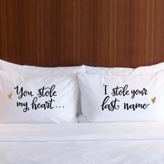 two pillows with the words, the anchor and the sail on them are sitting on a bed