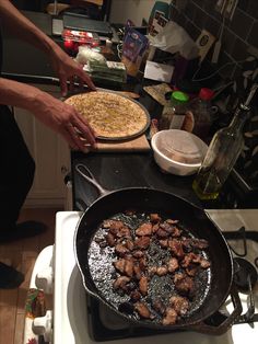 someone is cooking food in a skillet on top of the stove and it's ready to be cooked