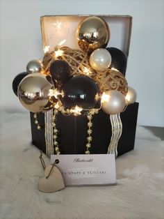 a black box with gold and white ornaments in it