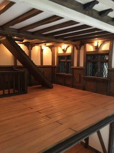 an empty room with wooden floors and beams