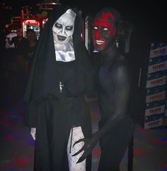 two people dressed in costumes standing next to each other