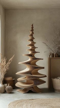 a large wooden christmas tree sitting on top of a floor next to vases and baskets