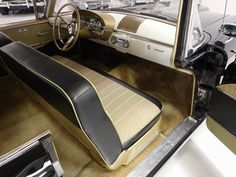 the interior of an old car is clean and ready to be used as a showroom