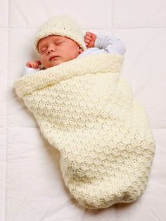 a newborn baby wrapped in a white blanket