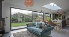 a living room filled with furniture and a fire place in front of a sliding glass door