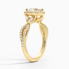 a yellow gold engagement ring with an oval shaped center stone surrounded by small round brilliant cut diamonds