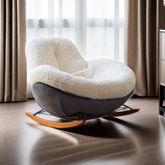 a modern rocking chair in the middle of a living room