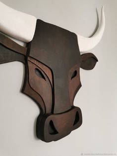 a wooden bull's head mounted on the wall