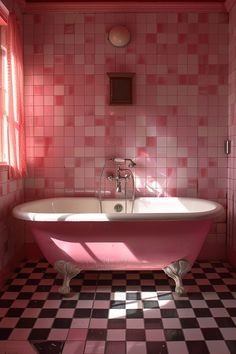 a pink bath tub sitting next to a window in a bathroom with checkered flooring