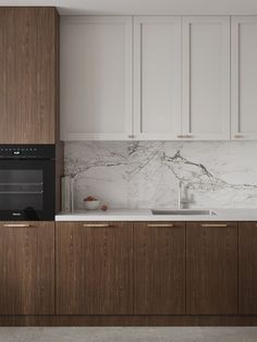 a kitchen with marble counter tops and wooden cabinets