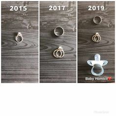 three pictures of different rings hanging on the side of a wooden wall, and one has a baby's pacifier attached to it