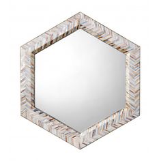 a mirror that is sitting on top of a table with a white and blue pattern