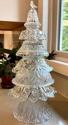 a glass christmas tree sitting on top of a counter