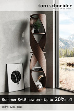 a corner shelf in the middle of a room next to a window with mountains outside