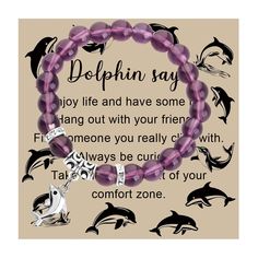 a purple beaded bracelet with dolphins on it and the words dolphinin say joy life and have some hang out with your friend