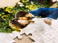 a man and woman kissing on a puzzle