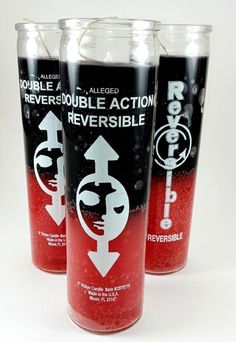 three red and black beverages are lined up on a white surface with the words rever - double action