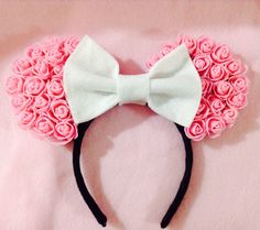 a minnie mouse ears with pink roses on it