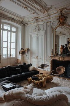 a living room filled with furniture and a fire place next to a mirror on the wall