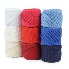 several different colors of yarn are shown in this image, including red, white, and blue