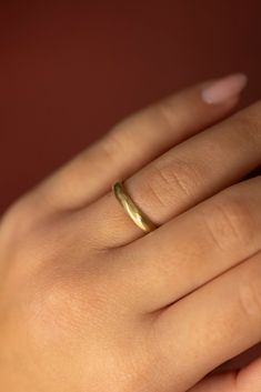 a woman's hand with a gold ring on it