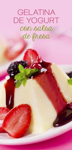 two white plates topped with cheesecake covered in fruit