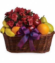 a basket filled with fruit and flowers