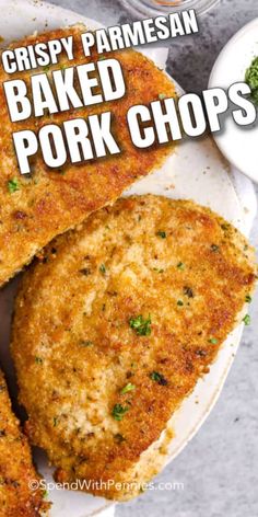 crispy parmesan baked pork chops on a white plate with dipping sauce