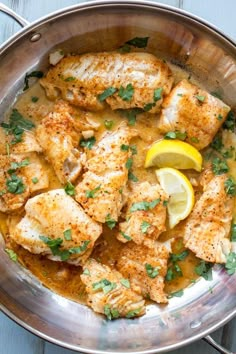 a pan filled with chicken and lemons on top of a table