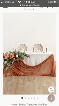 an image of a table setting with flowers and candles on it for the centerpiece