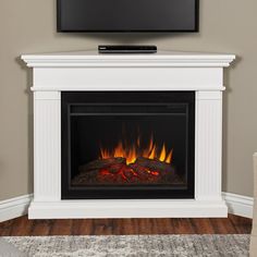 a flat screen tv mounted on top of a fireplace