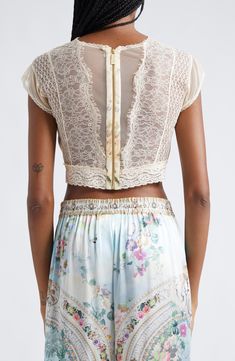 A faded floral print lends a vintage-inspired feel to this cropped silk top designed with corset-inspired cups and crystal-embellished lace. 15" length (size Medium) Exposed back-zip closure Jewel neck Cap sleeves Partially lined 100% silk with 100% nylon contrast Dry clean Imported Designer Clothing Lace Patchwork Crop Top, Bohemian Crop Top With Lace Trim, Fitted Lace Patchwork Crop Top, Fitted Lace Trim Crop Top For Festival, Fitted Crop Top With Lace Patchwork, Fitted Crop Top With Lace Trim For Festival, Fitted Cropped Crop Top With Lace Patchwork, Fitted Lace Crop Top For Festival, Vintage Cropped Top With Lace Trim