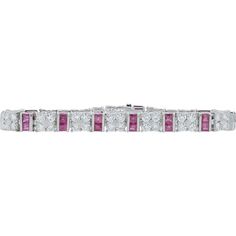 Step into a world of unparalleled luxury and elegance with this exquisite Platinum Ruby and Diamond Bracelet. This piece boasts an opulent design that effortlessly combines classic glamour with modern sophistication. The bracelet is adorned with a staggering 6.40 carats of rubies, each stone radiating a deep, mesmerizing red that symbolizes love, passion, and courage. Alternating with the rubies, 6.00 carats of pristine diamonds sparkle with unmatched brilliance, their clear, flawless facets cap Formal Platinum Pave Setting Tennis Bracelet, Platinum Tennis Bracelet With Pave Setting For Formal Occasions, Formal Platinum Tennis Bracelet With Pave Setting, Classic White Bracelet With Pave Setting, White Classic Bracelet With Pave Setting, Luxury White Diamond Bracelet Hand Set, Luxury White Pavé Setting Bracelet, Luxury White Bracelet With Pave Setting, White Diamond Bracelet With Pave Setting For Formal