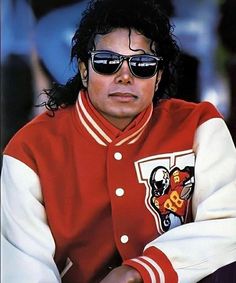 a man wearing sunglasses and a red jacket