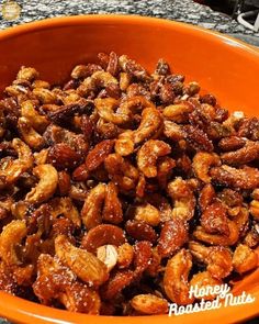 a bowl filled with nuts sitting on top of a counter