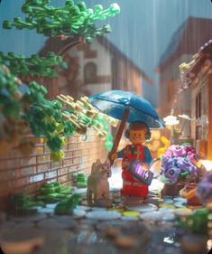 there is a lego man holding an umbrella in the rain with his dog and cat