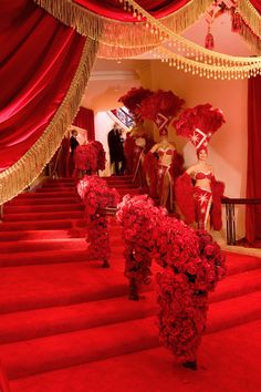 the red carpeted stairs are decorated with flowers