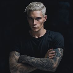 a man with white hair and tattoos on his arms