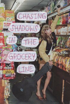 a woman standing in front of a grocery store holding up signs that say chasing shadows in the grocery line