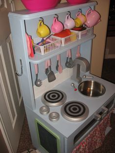 a toy stove with pots and pans on it