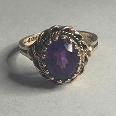 A Regal Antique Ladies Ring Adorned With A Stunning Purple Oval Cut Amethyst In The Center, The Deep Purple Hue Is Complimented Beautifully By A Halo Of Rope Shaped 10k Yellow Gold. This Ring Has A Classic Design That Is Perfect For Special Occasions Or Everyday Wear And Is Available In Size 5.5 Mm . Amethyst Is Birthstone Of February And Is Considered A Stone Of Protection, Good Luck , Tranquility And Is Believed To Have Healing Properties . Don’t Miss The Opportunity To Own A Piece Of History. Victorian 14k Amethyst Oval Ring, Gold Amethyst Oval Cabochon Ring, Oval Amethyst Jewelry Collectible, Luxury Polished Amethyst Oval Cabochon Ring, Luxury Formal Amethyst Ring, Oval Cabochon, Oval Amethyst Ring, Purple Hues, Amethyst Ring, Purple Gold