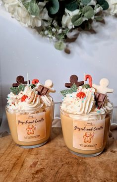 two jars filled with whipped cream and toppings sitting on top of a wooden table