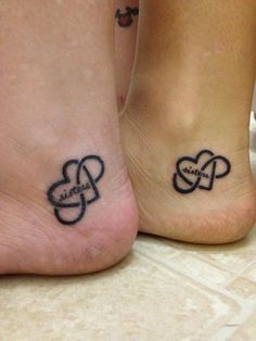 two people with matching tattoos on their feet, one has an intertwined heart tattoo