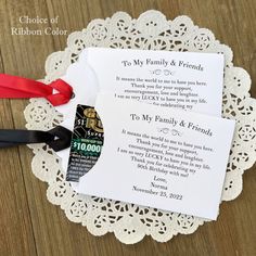 two pieces of paper on top of a doily with scissors and ribbon attached to it